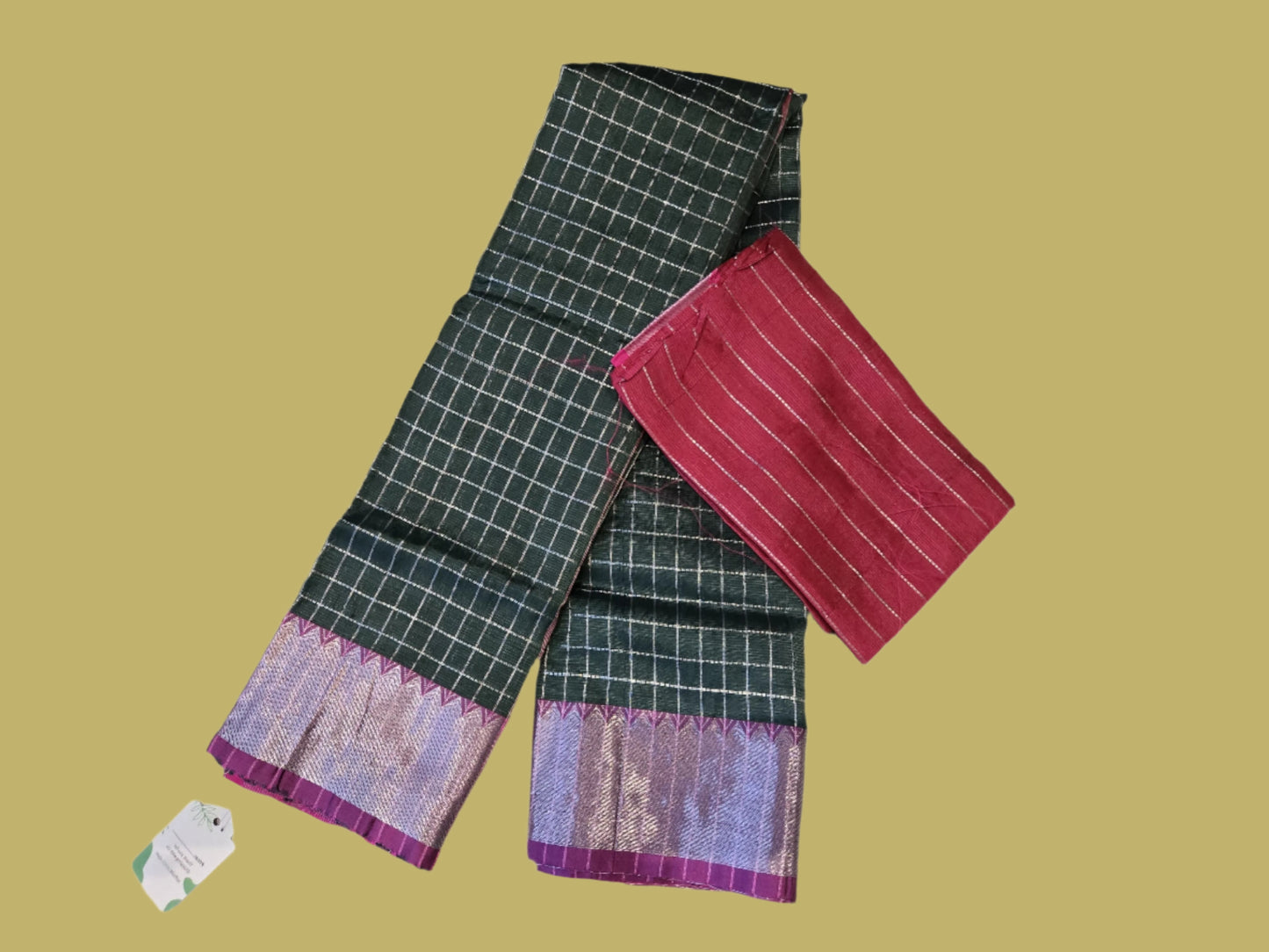 Bottle green and dark pink semi-pattu silk saree, beautifully adorned with an allover silver zari checked pattern and a graceful silver zari-woven border.