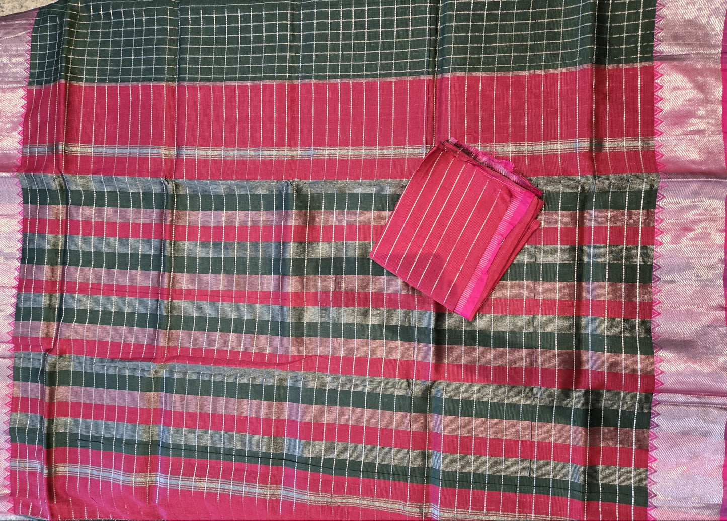 Bottle green and dark pink semi-pattu silk saree, beautifully adorned with an allover silver zari checked pattern and a graceful silver zari-woven border.